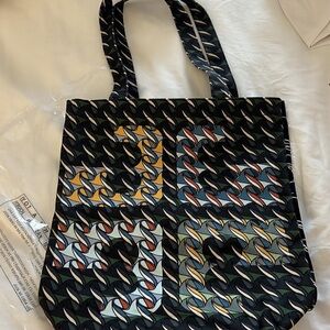 COPY - BRAND NEW TORY BURCH CURLY RIBBON $60
Size: 13 1/2" H x 12 1/2" L Tory B…